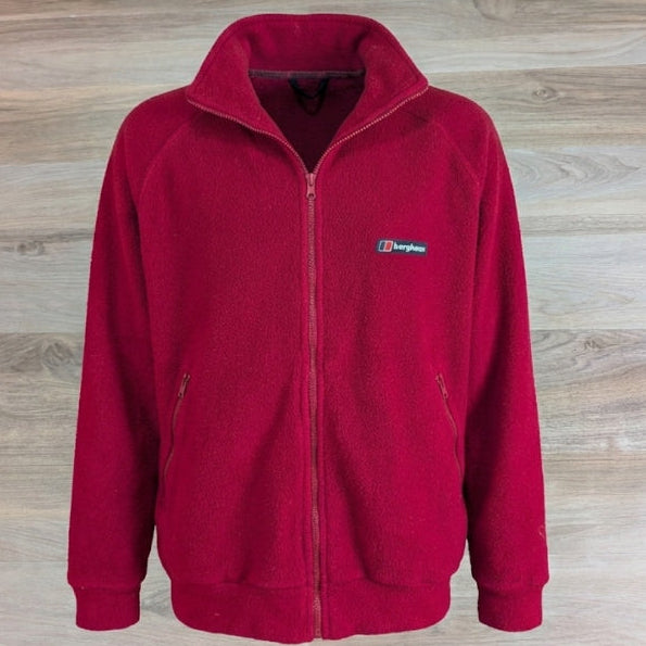 Berghaus red full-zip fleece jacket flat lay on wood background